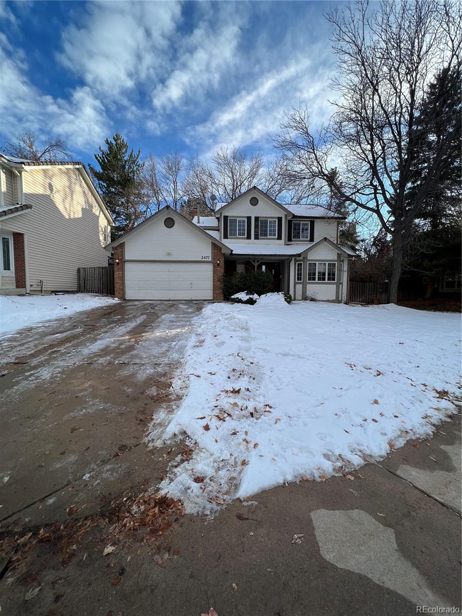 a front view of a house with a yard covered in snow