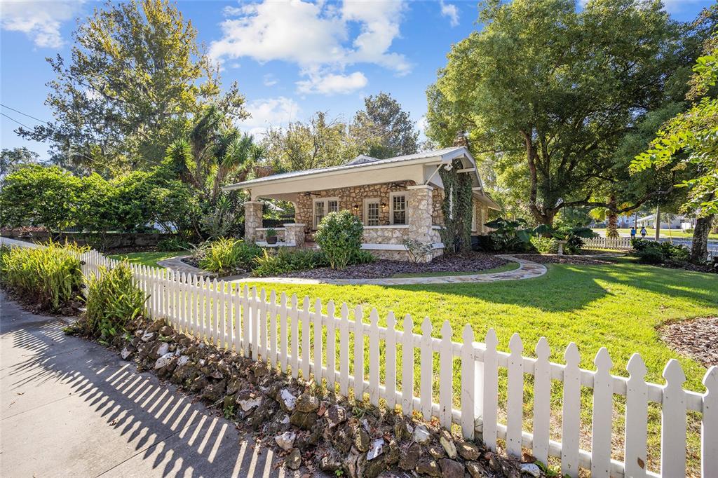 a view of house with backyard and garden