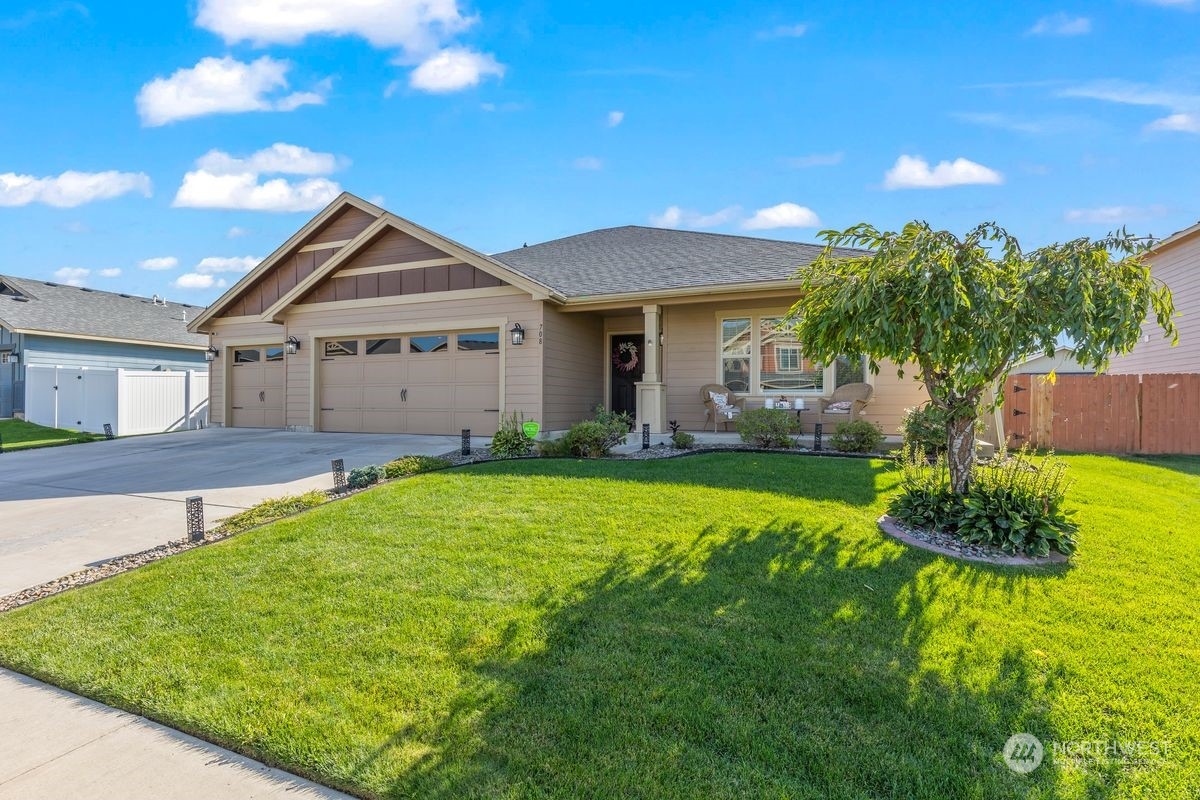 a front view of a house with a yard and garage