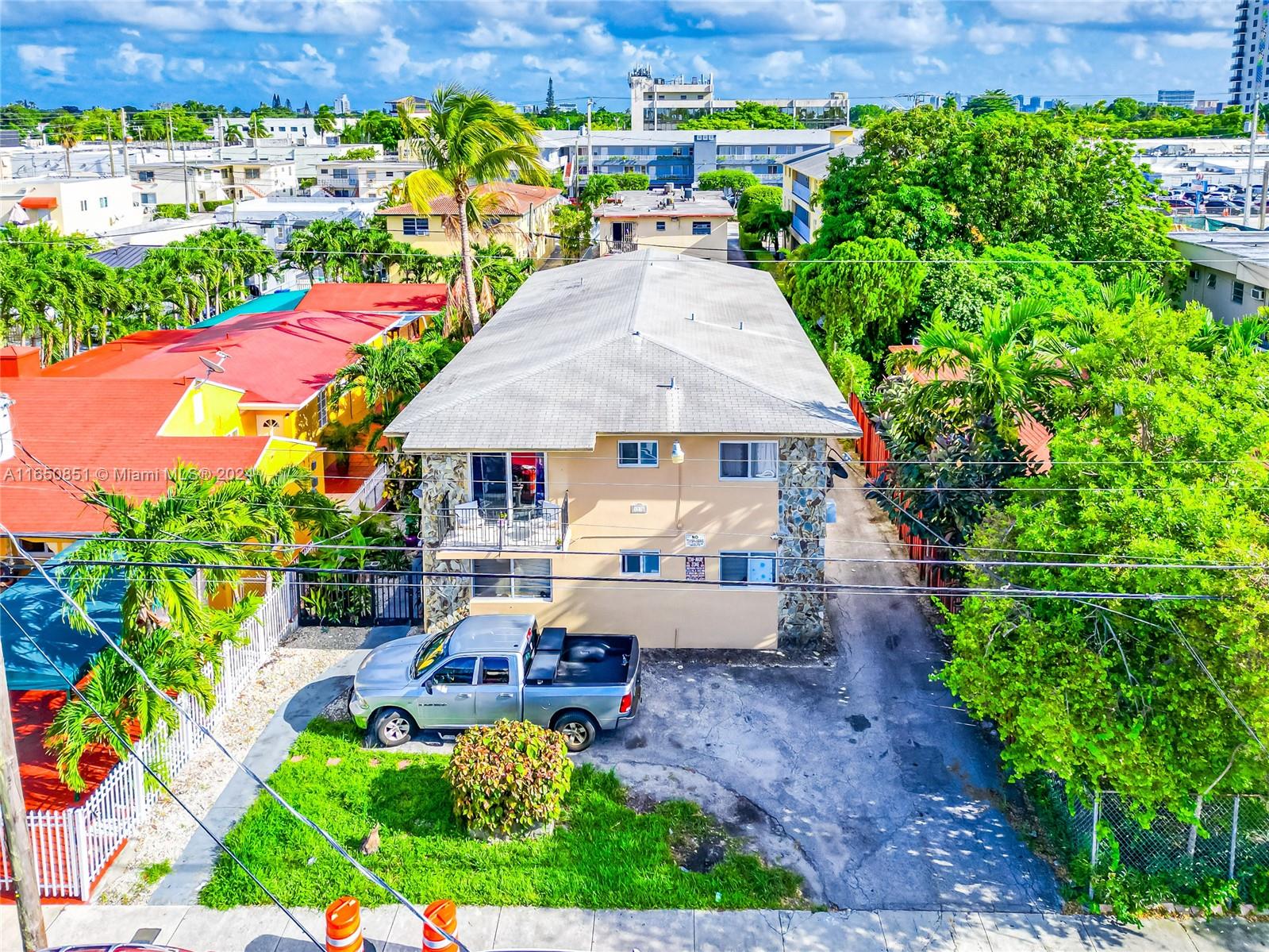 an aerial view of a house with swimming pool garden and patio