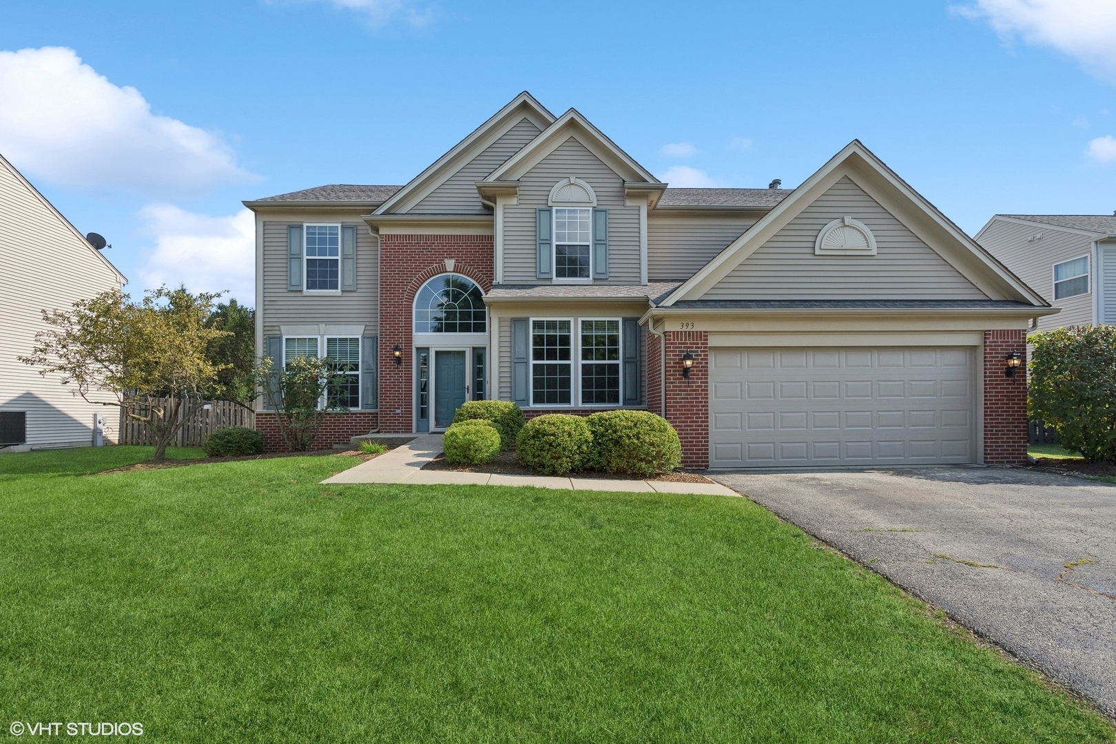 a front view of a house with a yard and garage