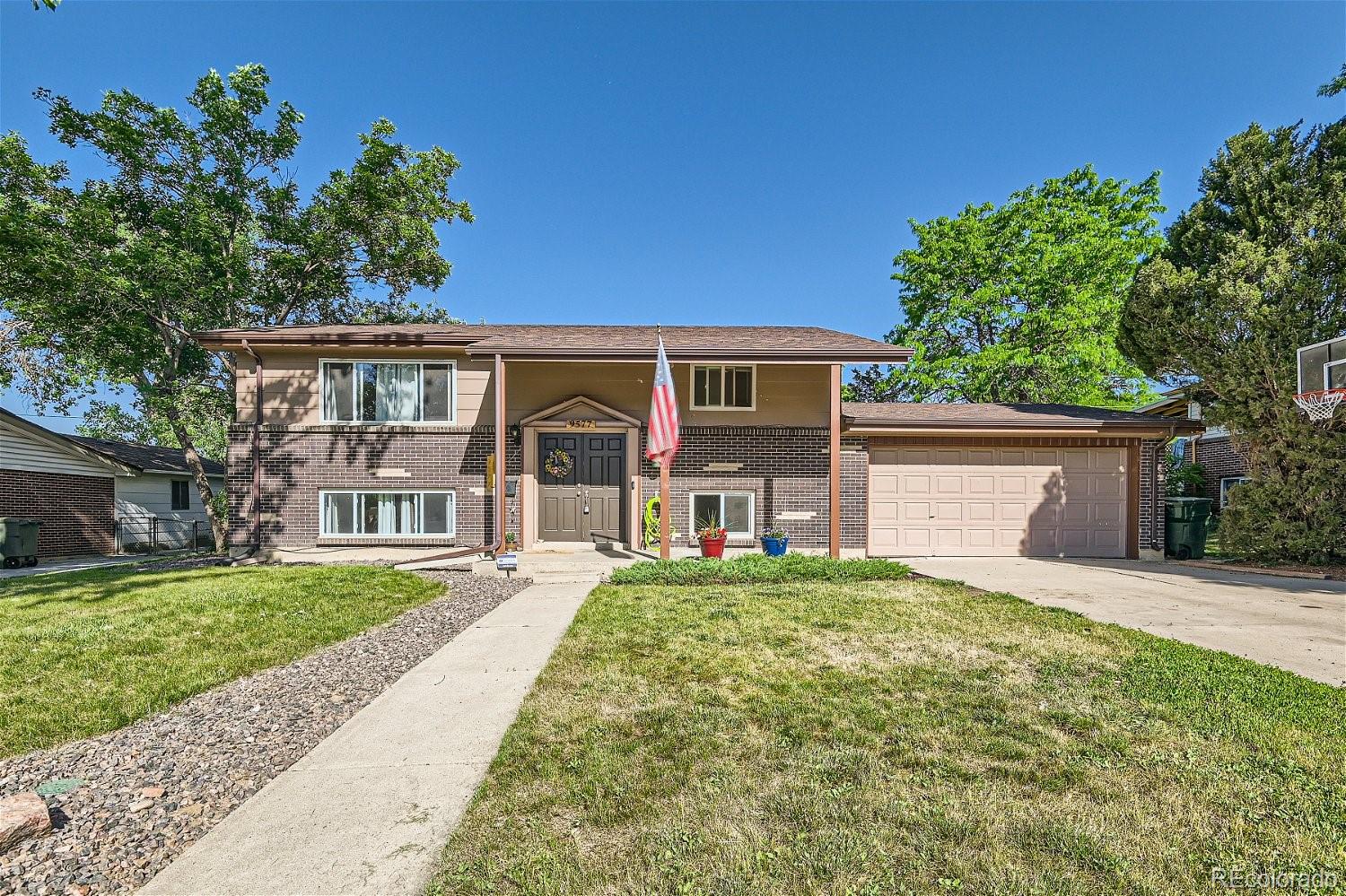 a front view of a house with a yard and garage