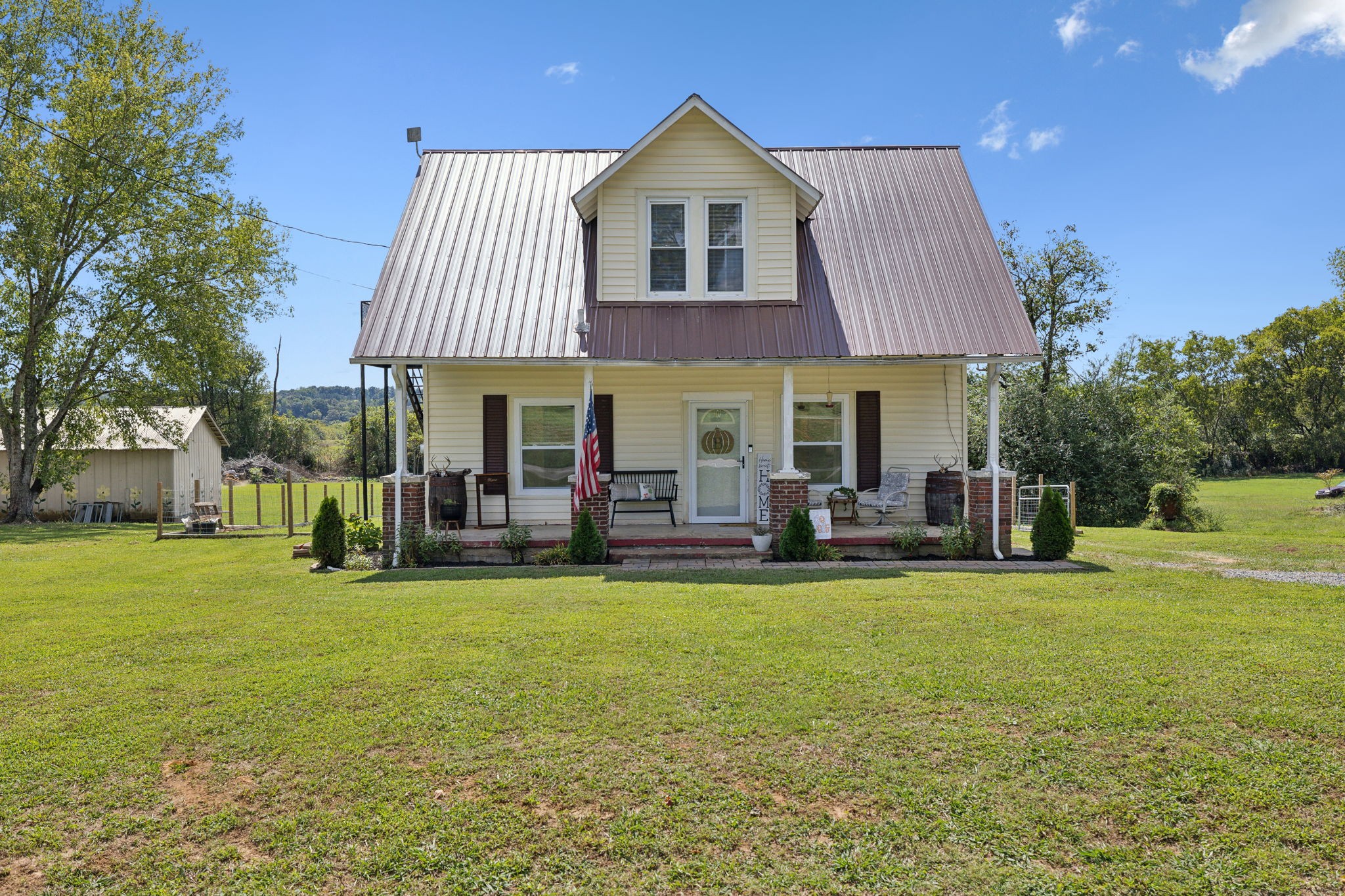 a view of a house with swimming pool and a yard