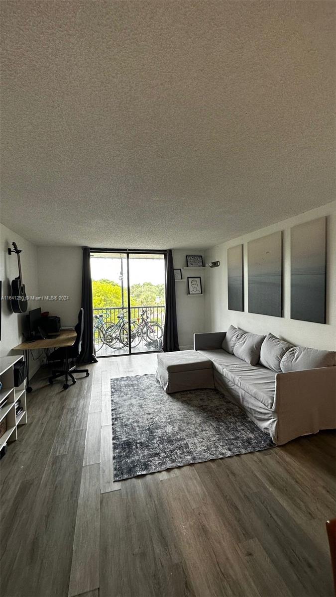 a living room with furniture window and a wooden floor