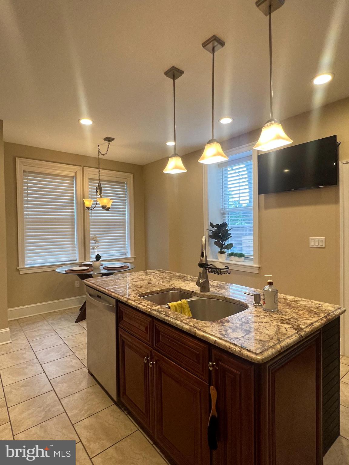 a kitchen with a sink a counter top space and cabinets