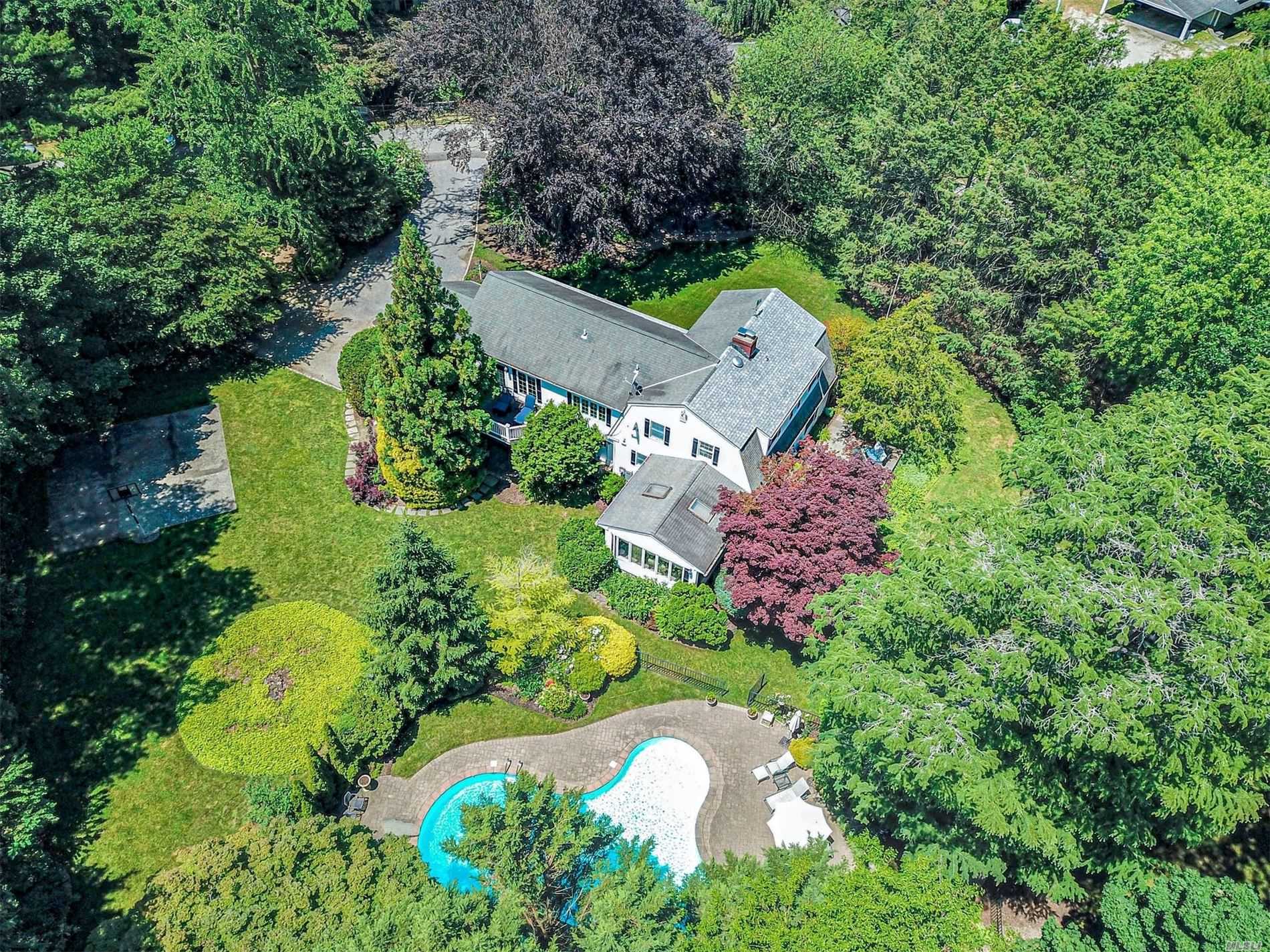 an aerial view of a house with a yard and outdoor seating