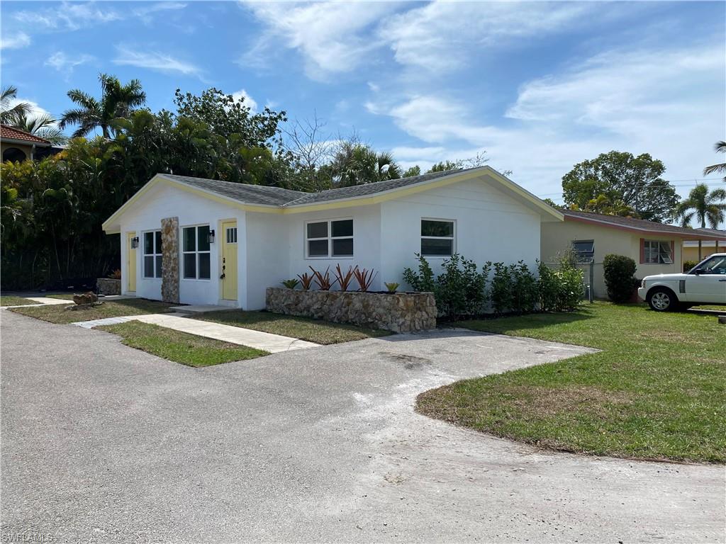 Single story home featuring a front lawn