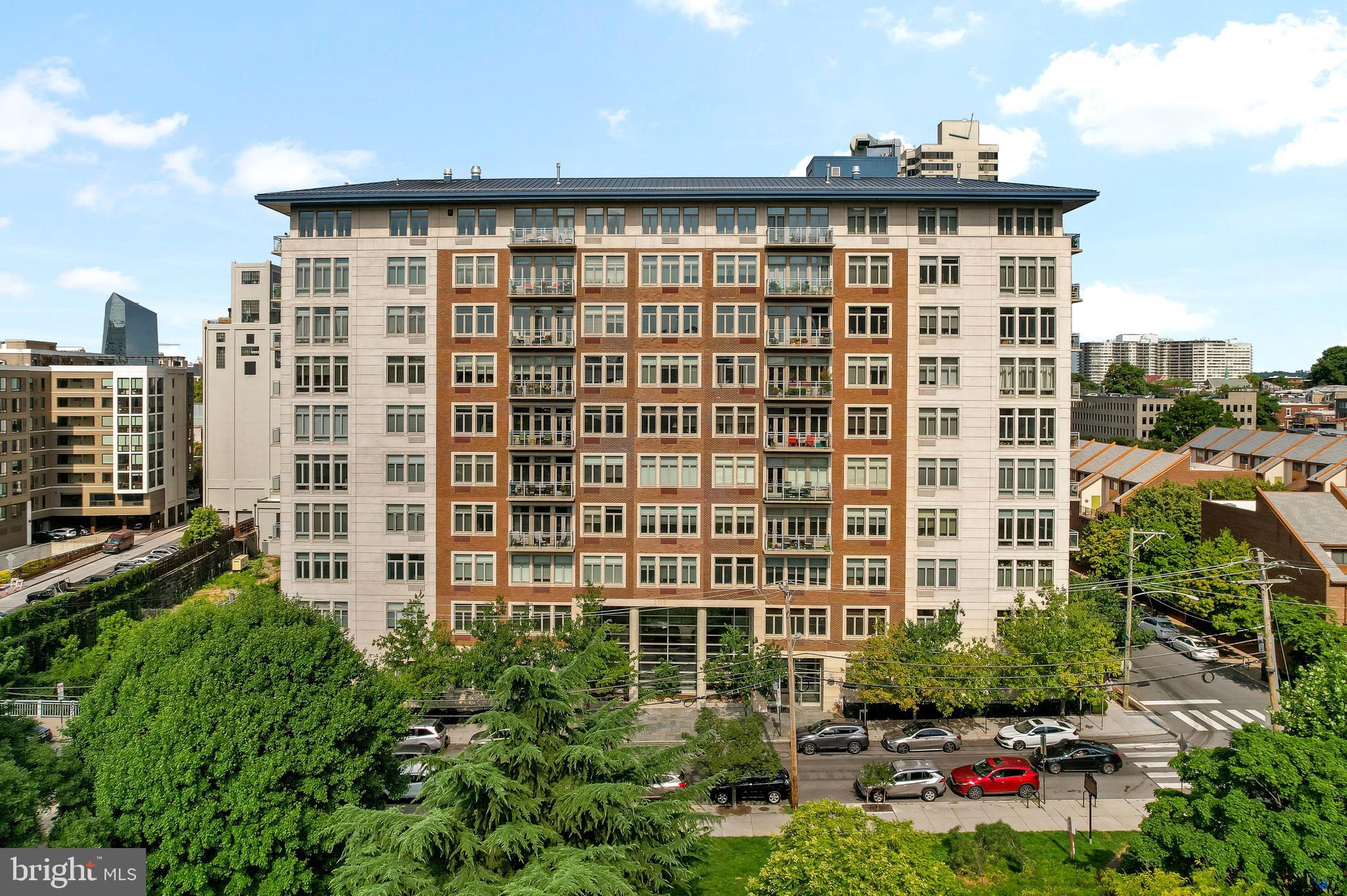 a front view of a residential apartment building with a yard