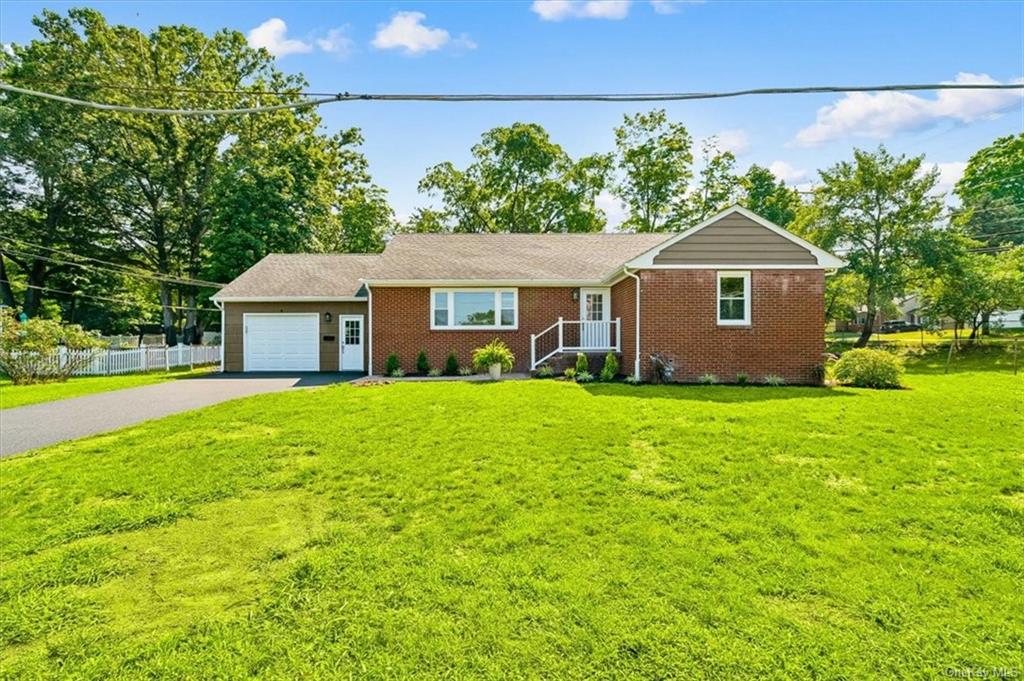 a front view of house with yard and green space