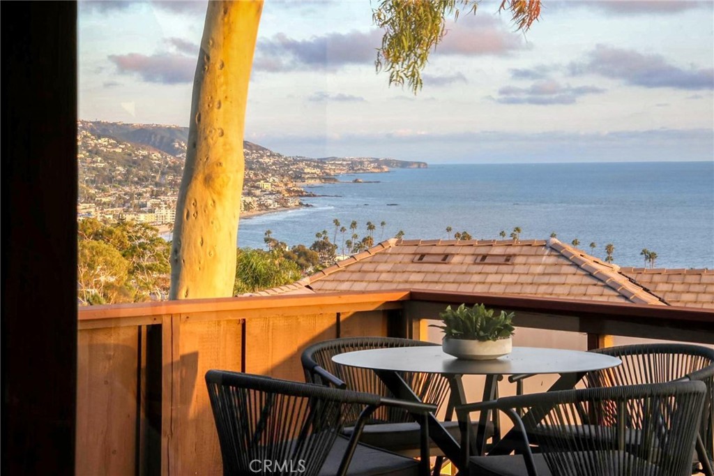 a view of a balcony with table and chairs