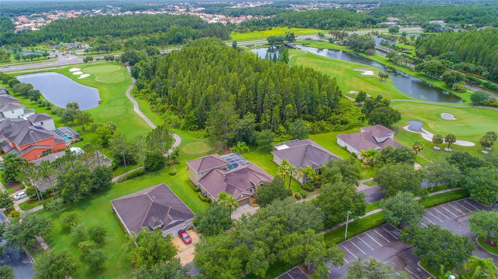 an aerial view of residential houses with outdoor space and pool