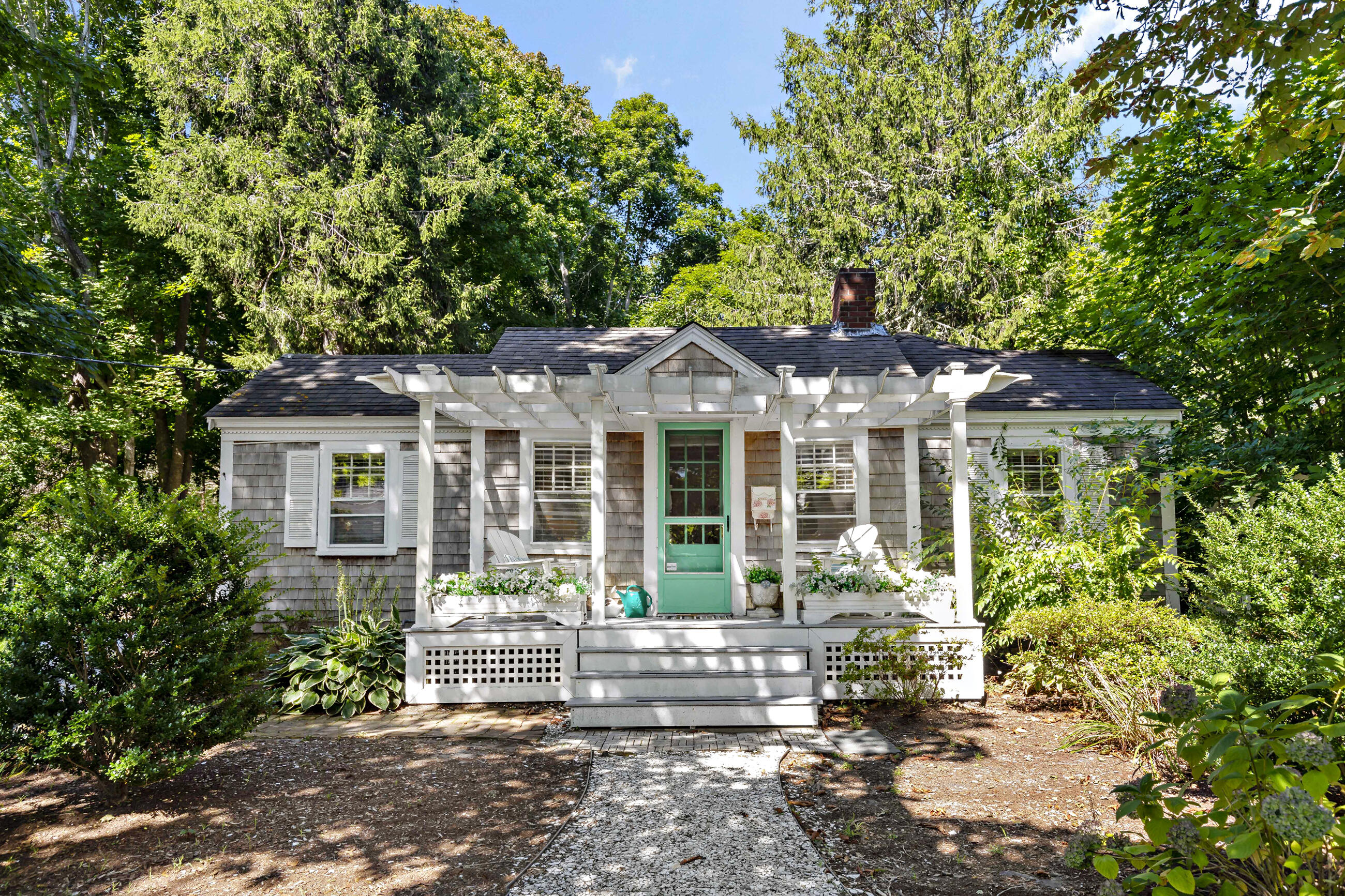 a front view of a house with a garden