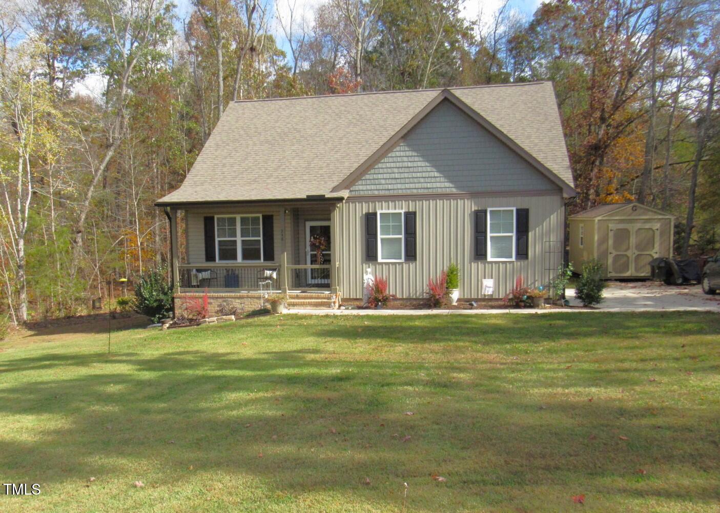 a view of a house with a yard patio and swimming pool