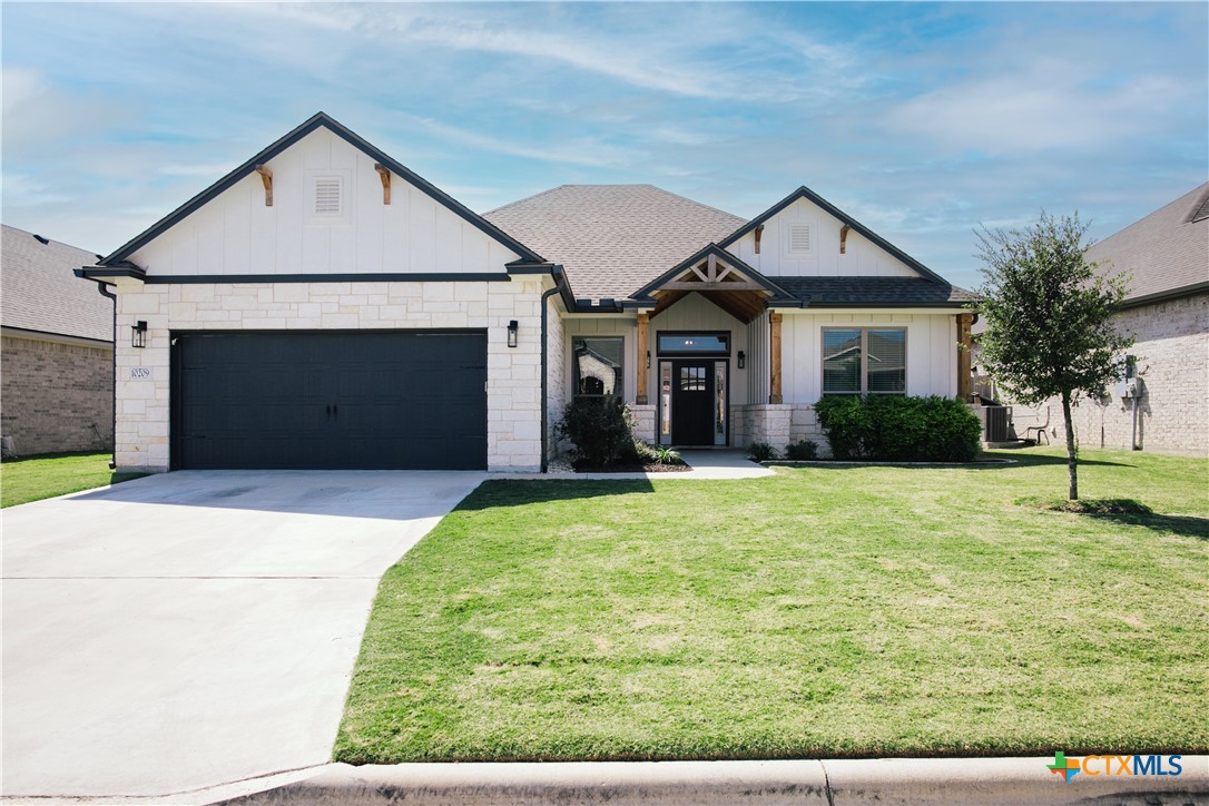 a front view of a house with a yard and garage