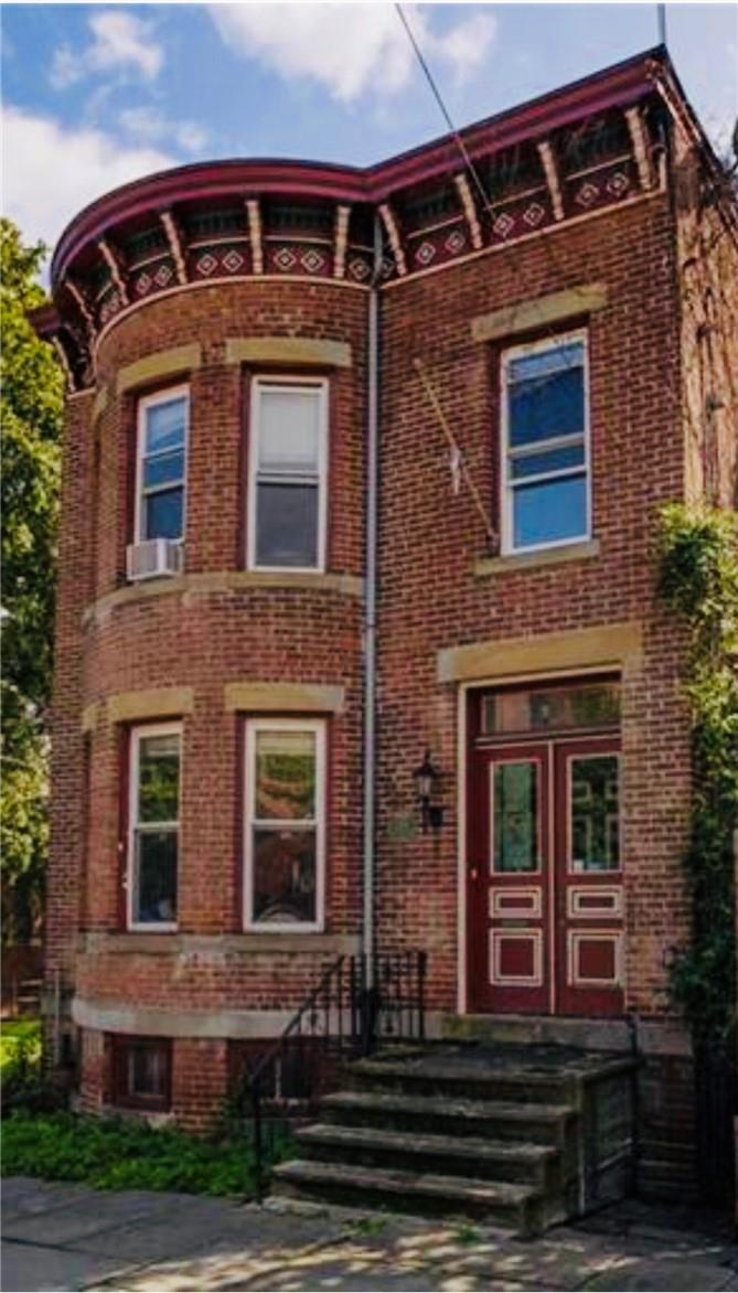 View of front of home featuring cooling unit