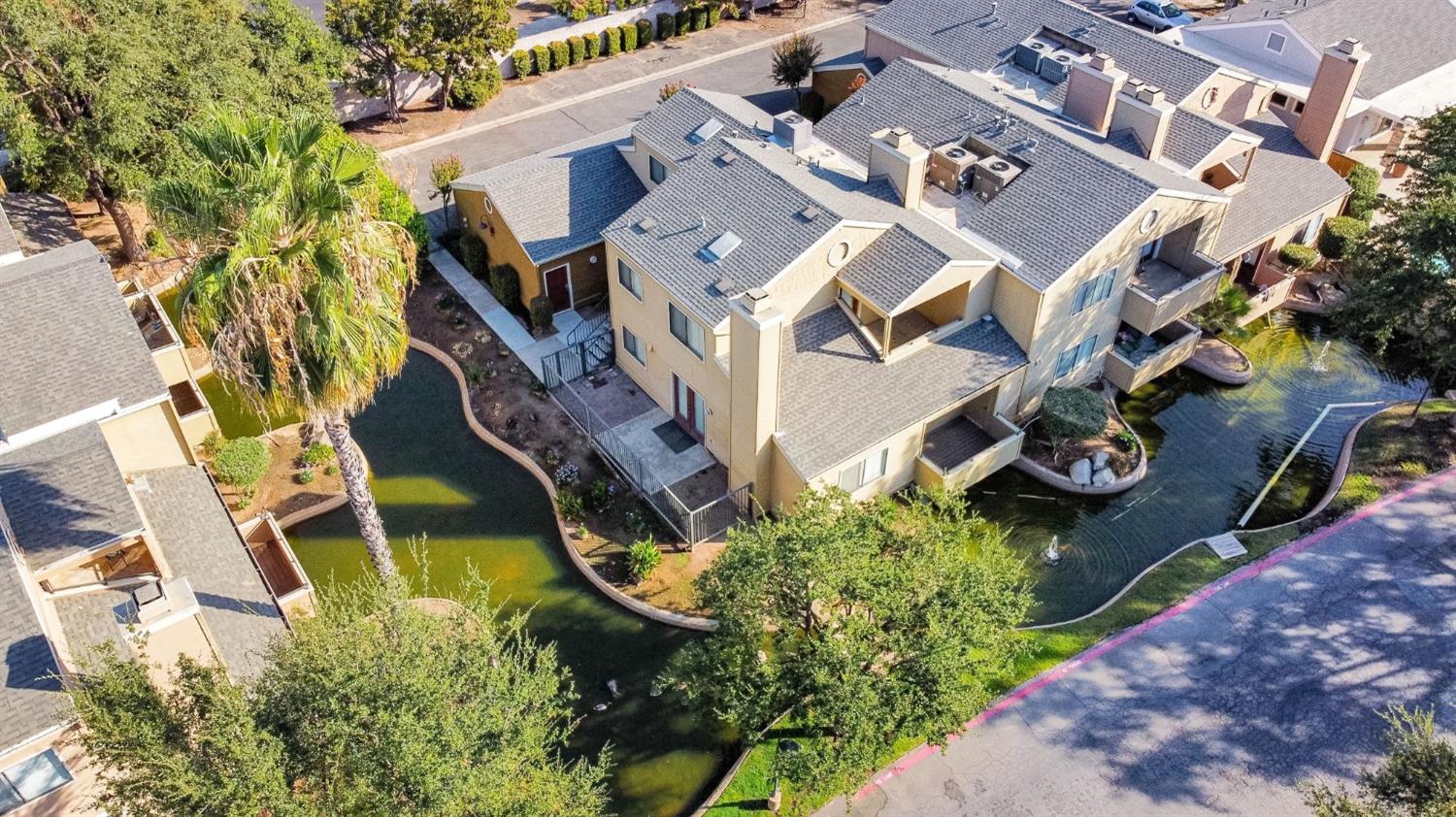 an aerial view of a house with garden space and street view