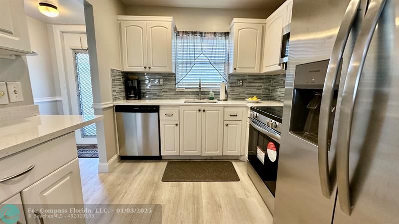 a kitchen with a sink stove and refrigerator