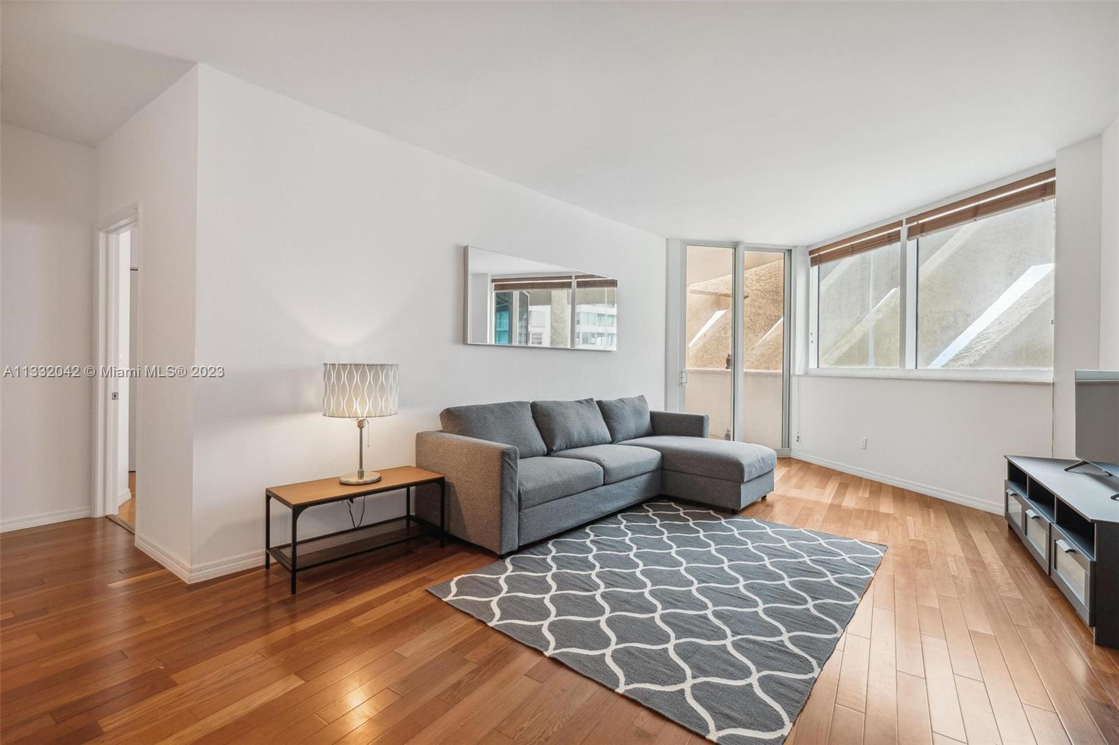 a living room with furniture and a rug