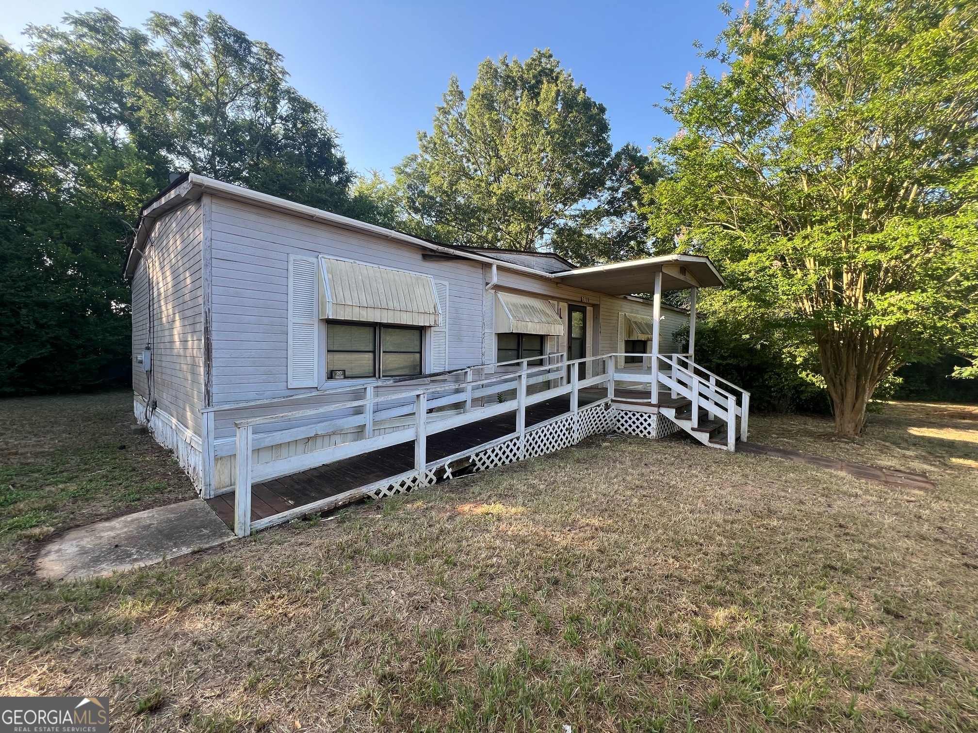 a view of a house with a yard and roof