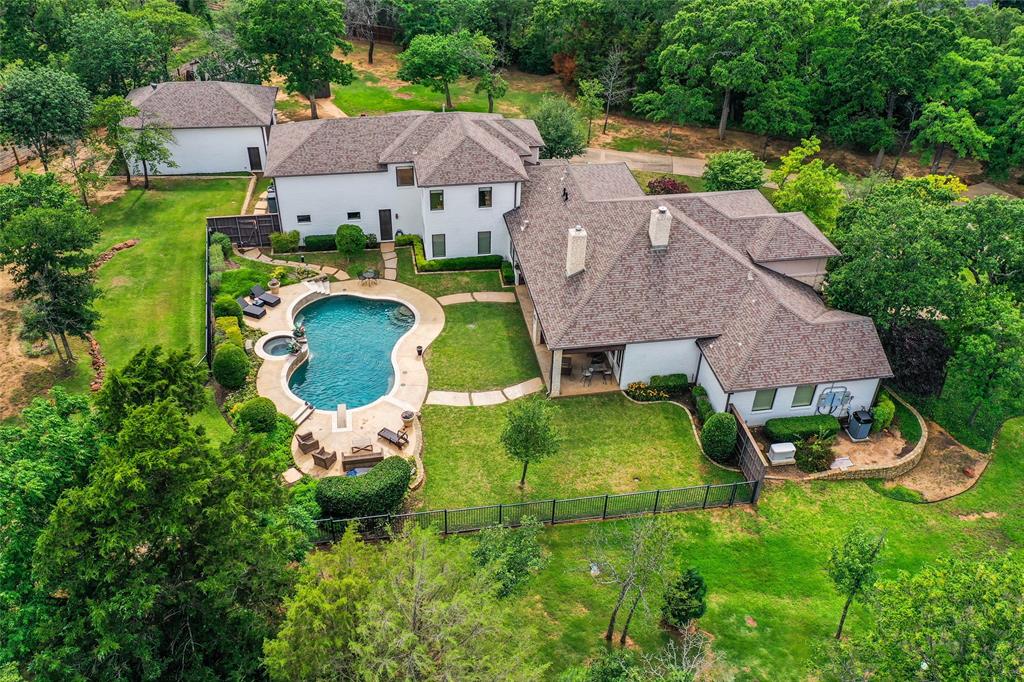 an aerial view of a house with garden space and street view