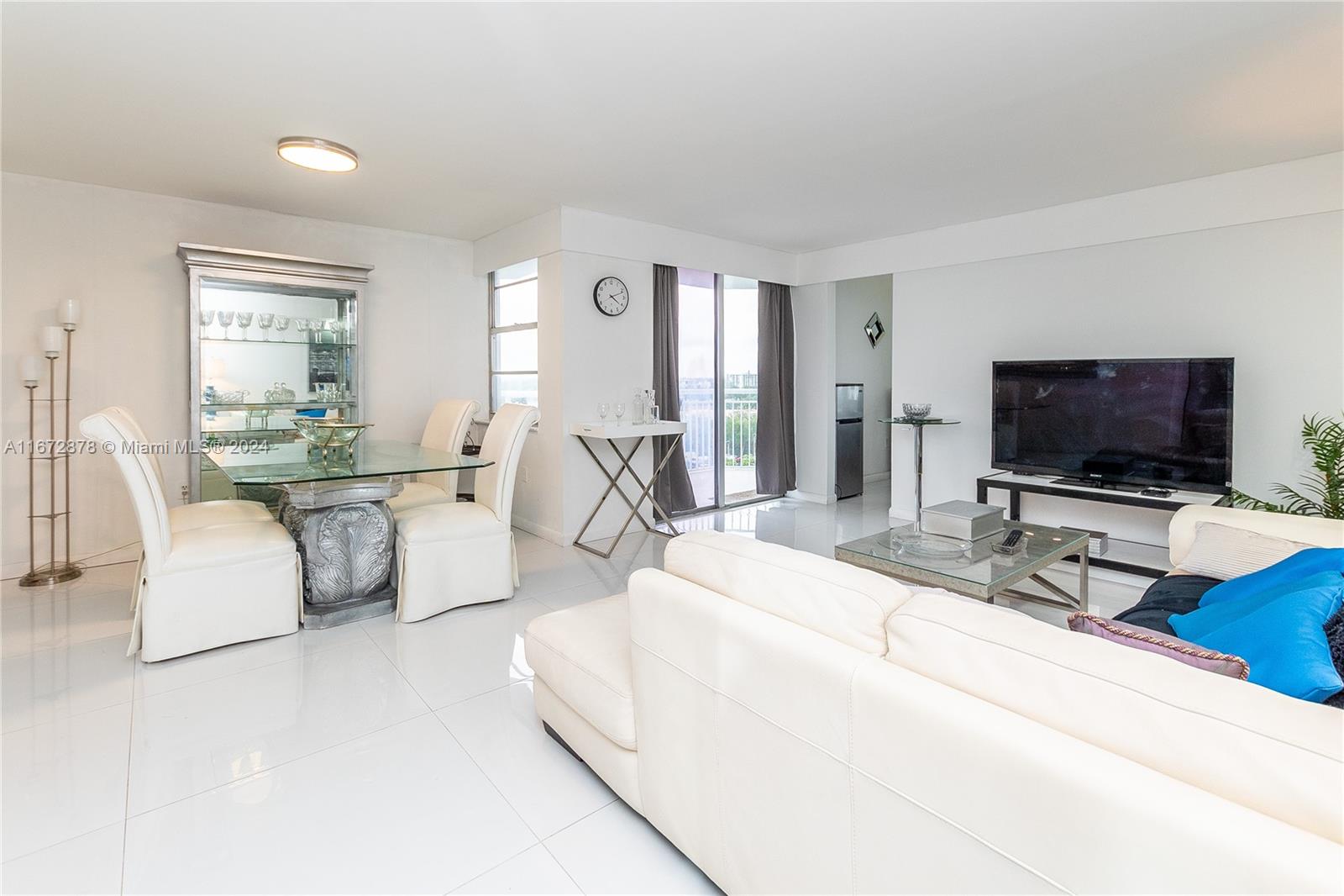 a bedroom with furniture and a flat screen tv