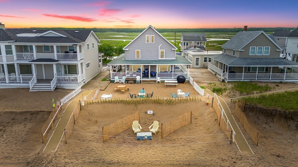 a view of a house with pool lawn chairs and a yard