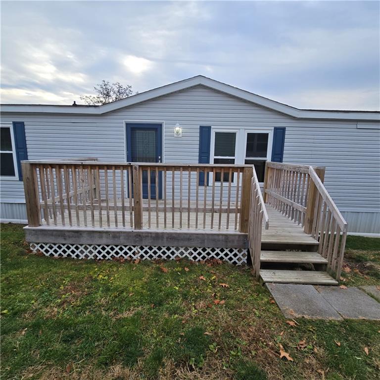 a view of a house with a wooden deck