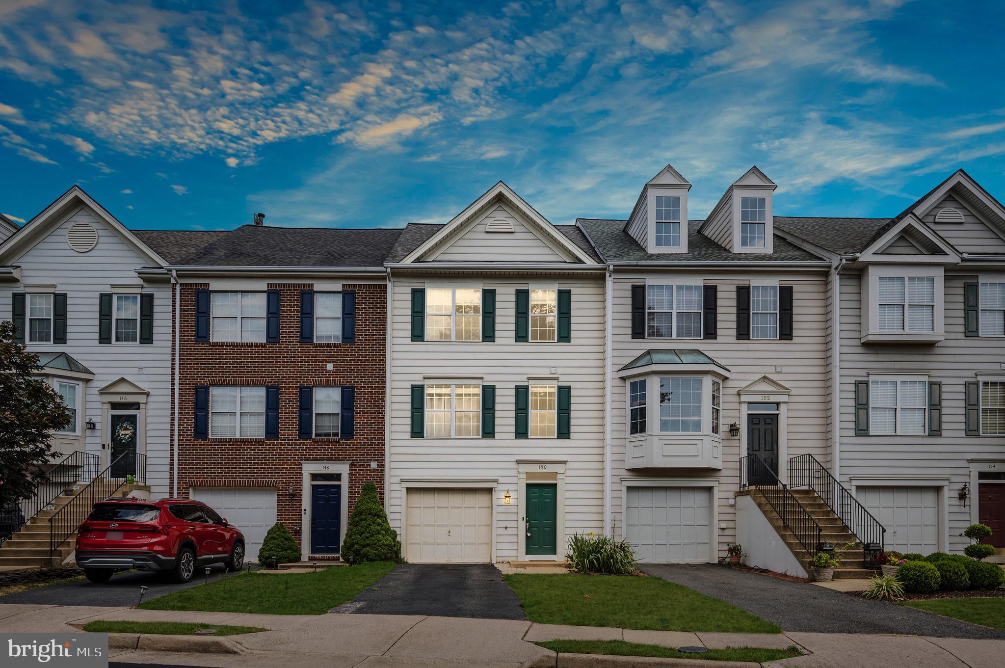 a front view of a residential apartment building with a yard