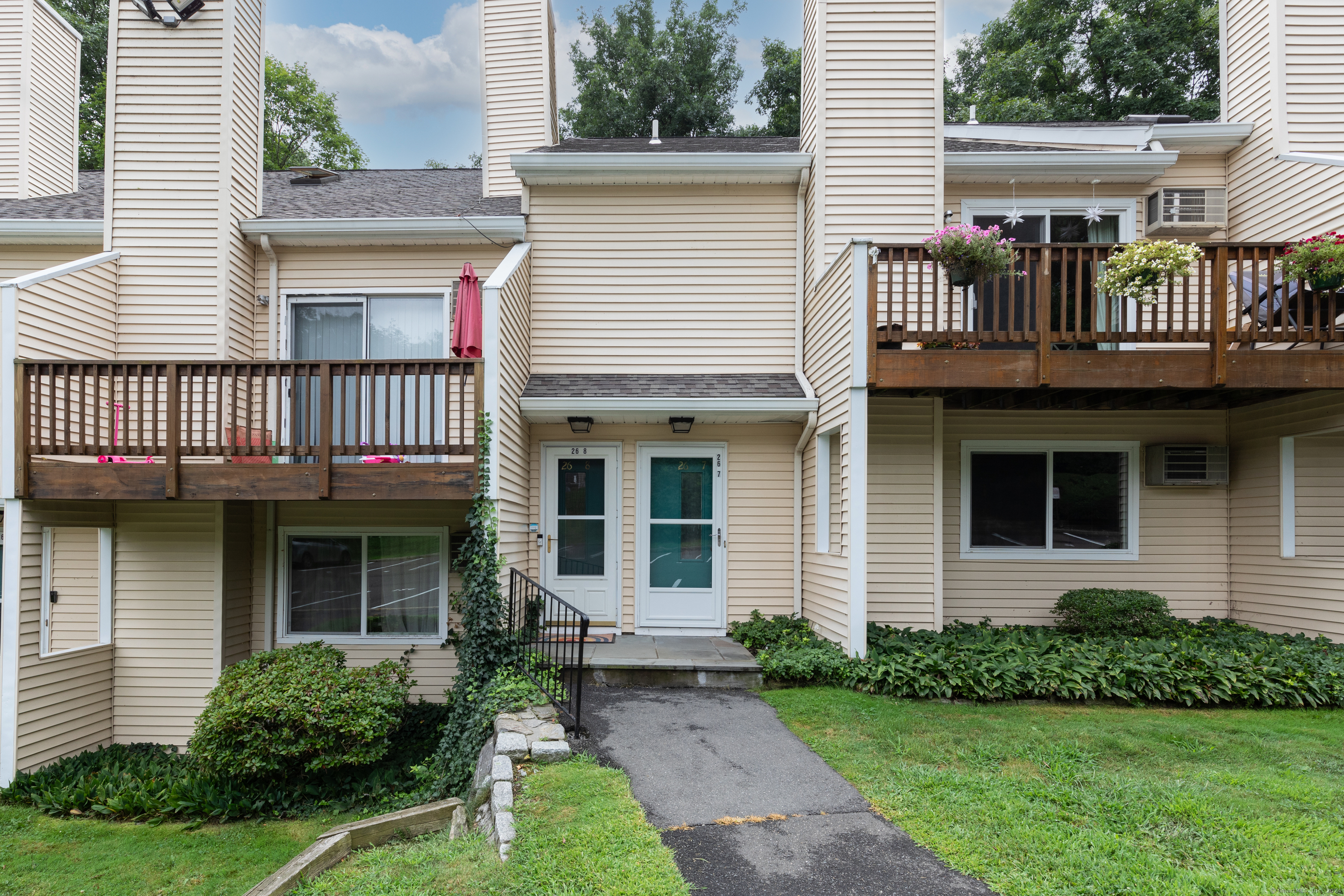 a front view of a house with a yard and outdoor seating