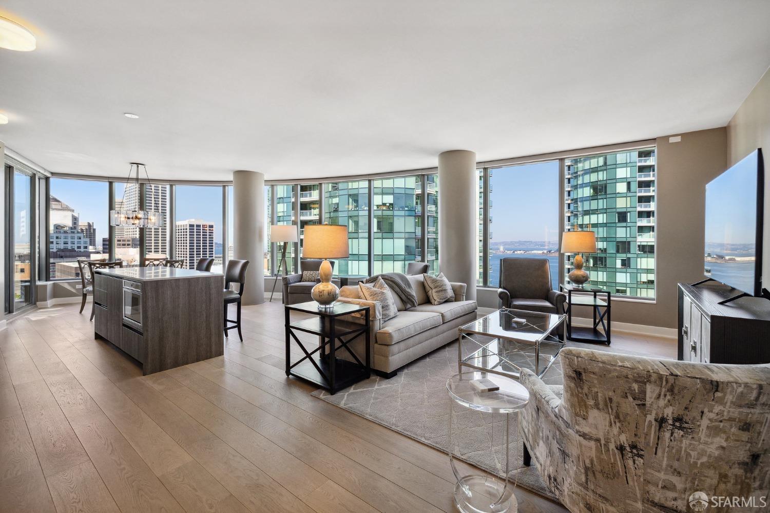 a living room with furniture flat screen tv and large window