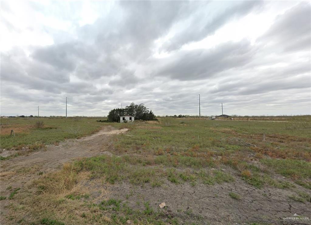 a view of a field with an ocean view