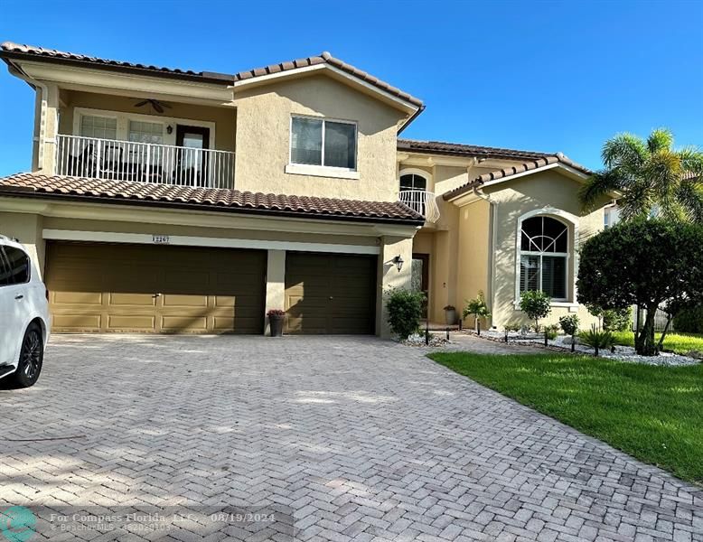 a view of a house with a yard and garage