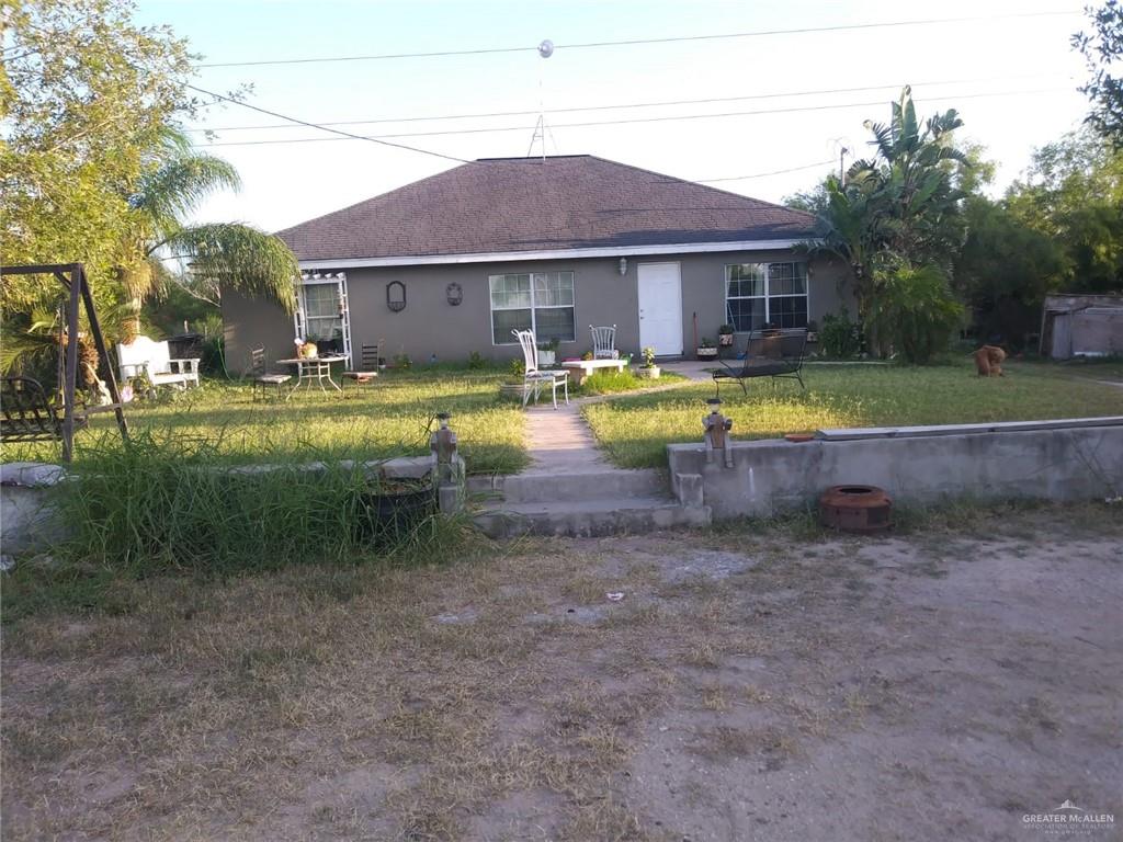 a view of a house with swimming pool and a yard