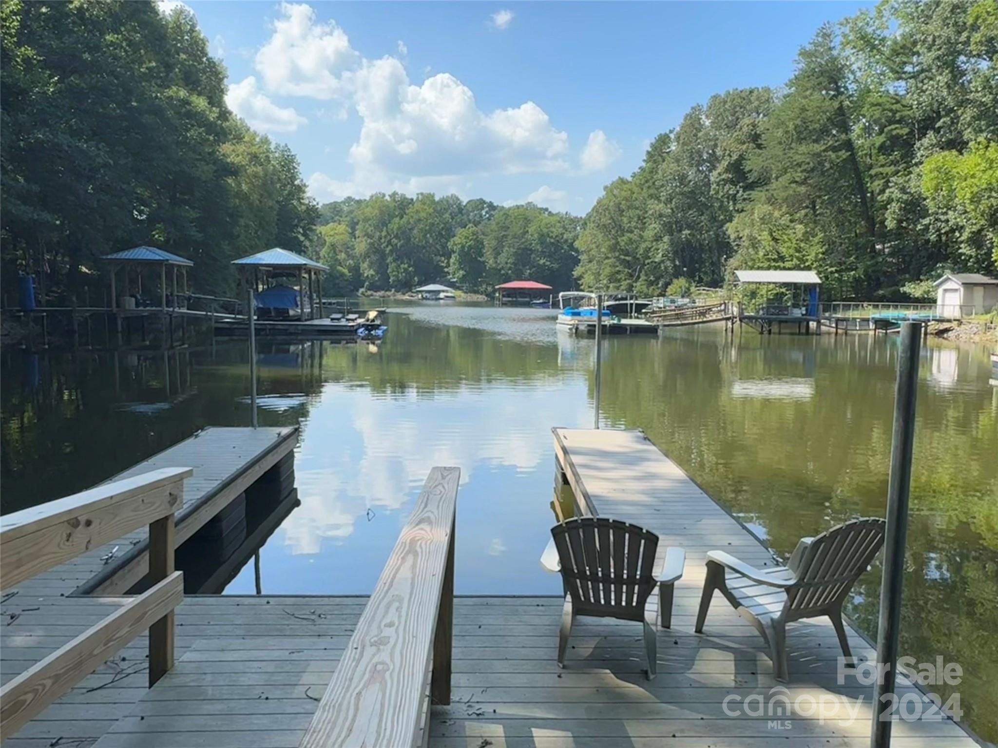 a view of a lake with a table and chairs