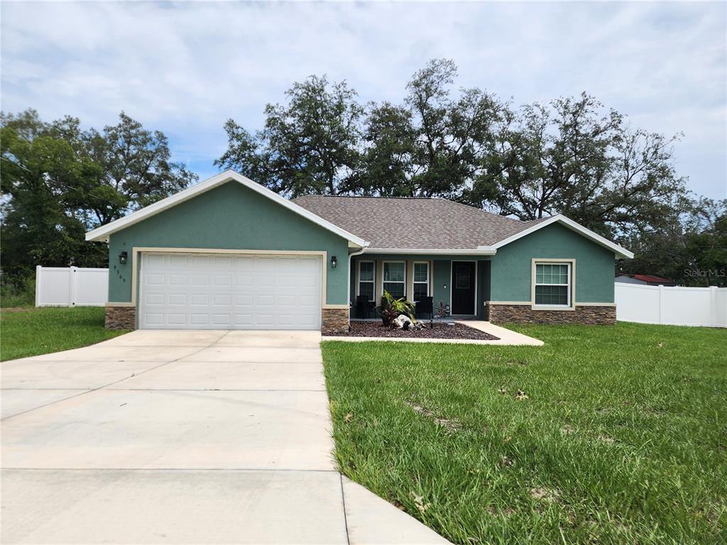 a front view of house with yard and green space