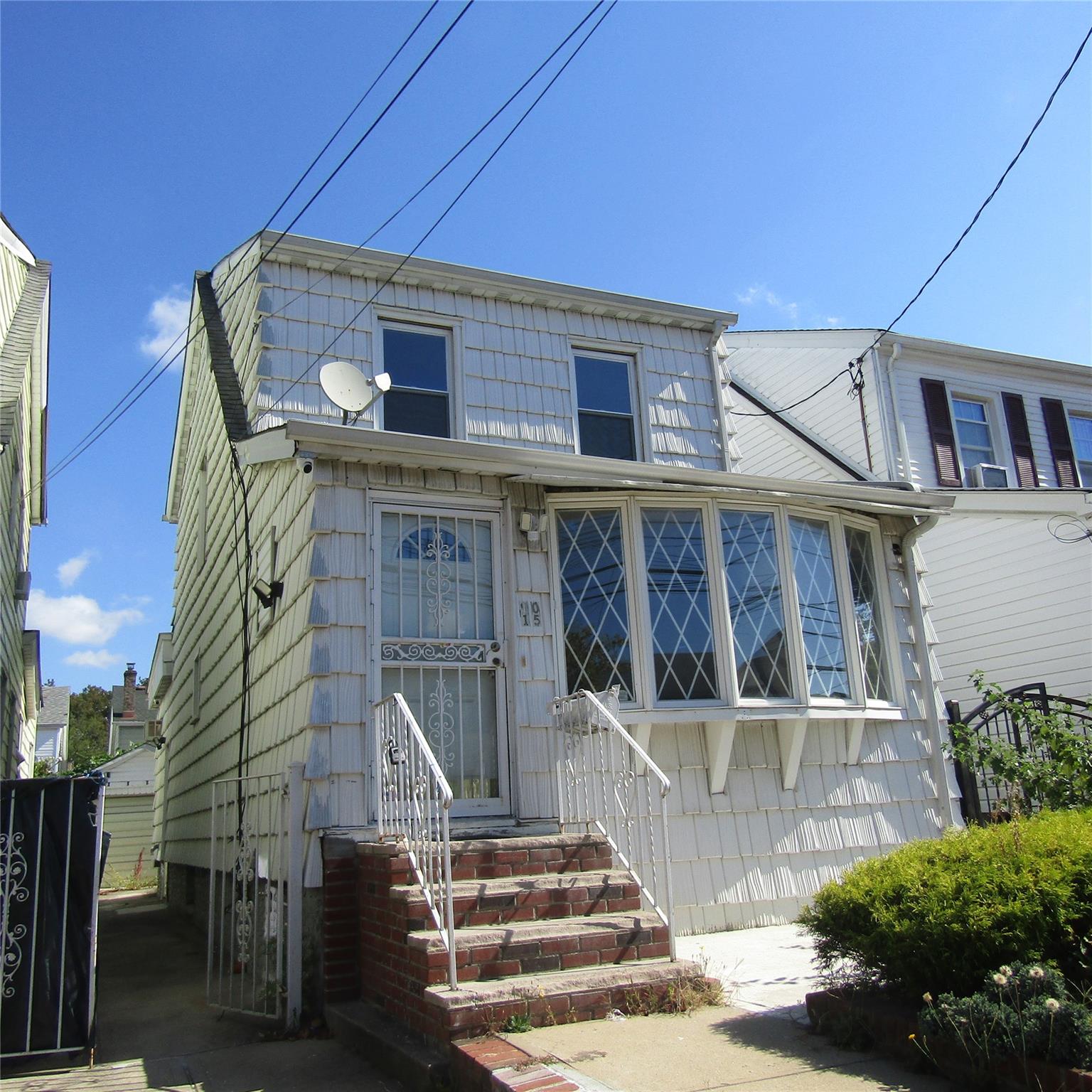 a front view of a house with a small yard