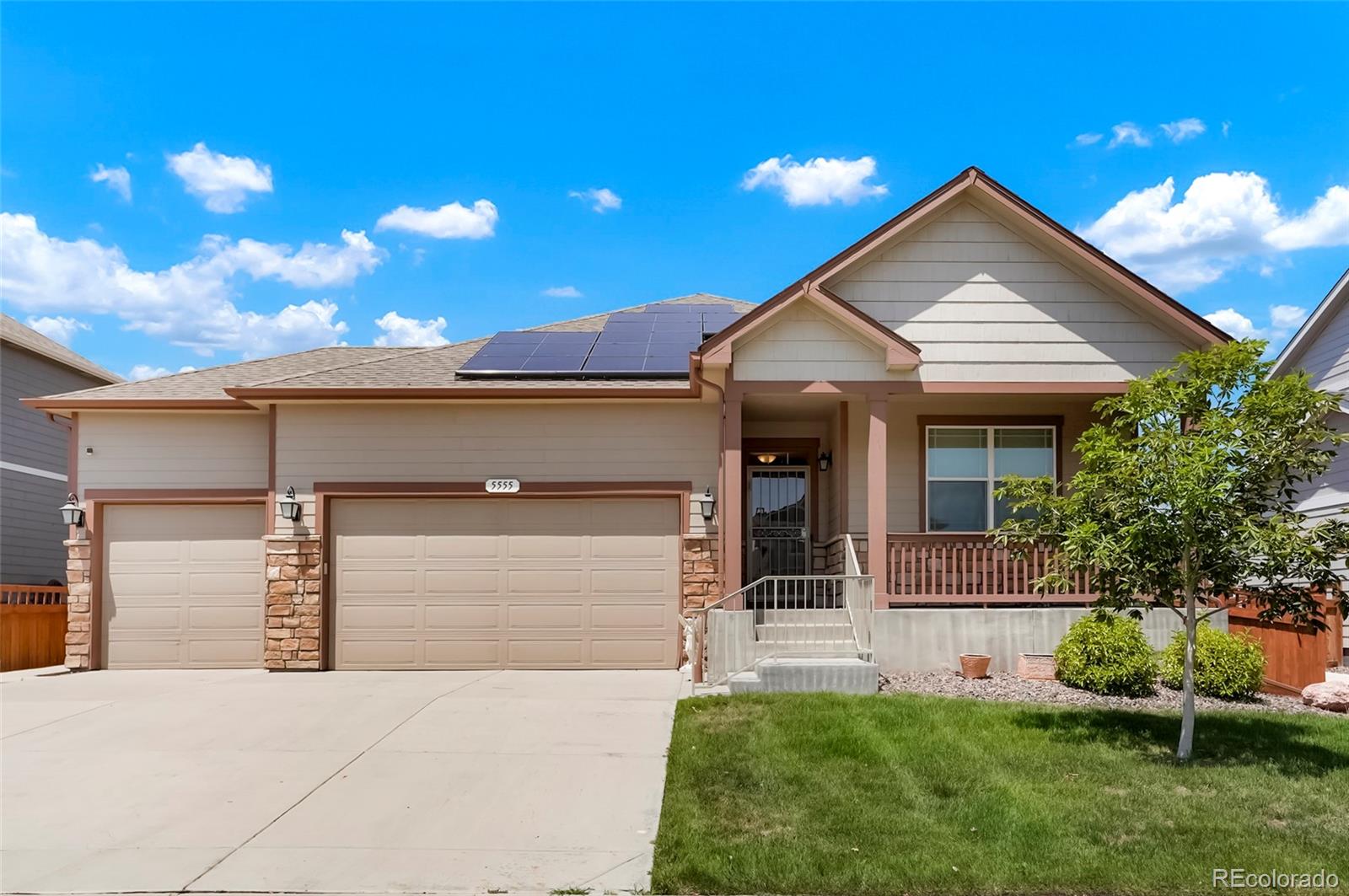 a front view of a house with a yard and garage