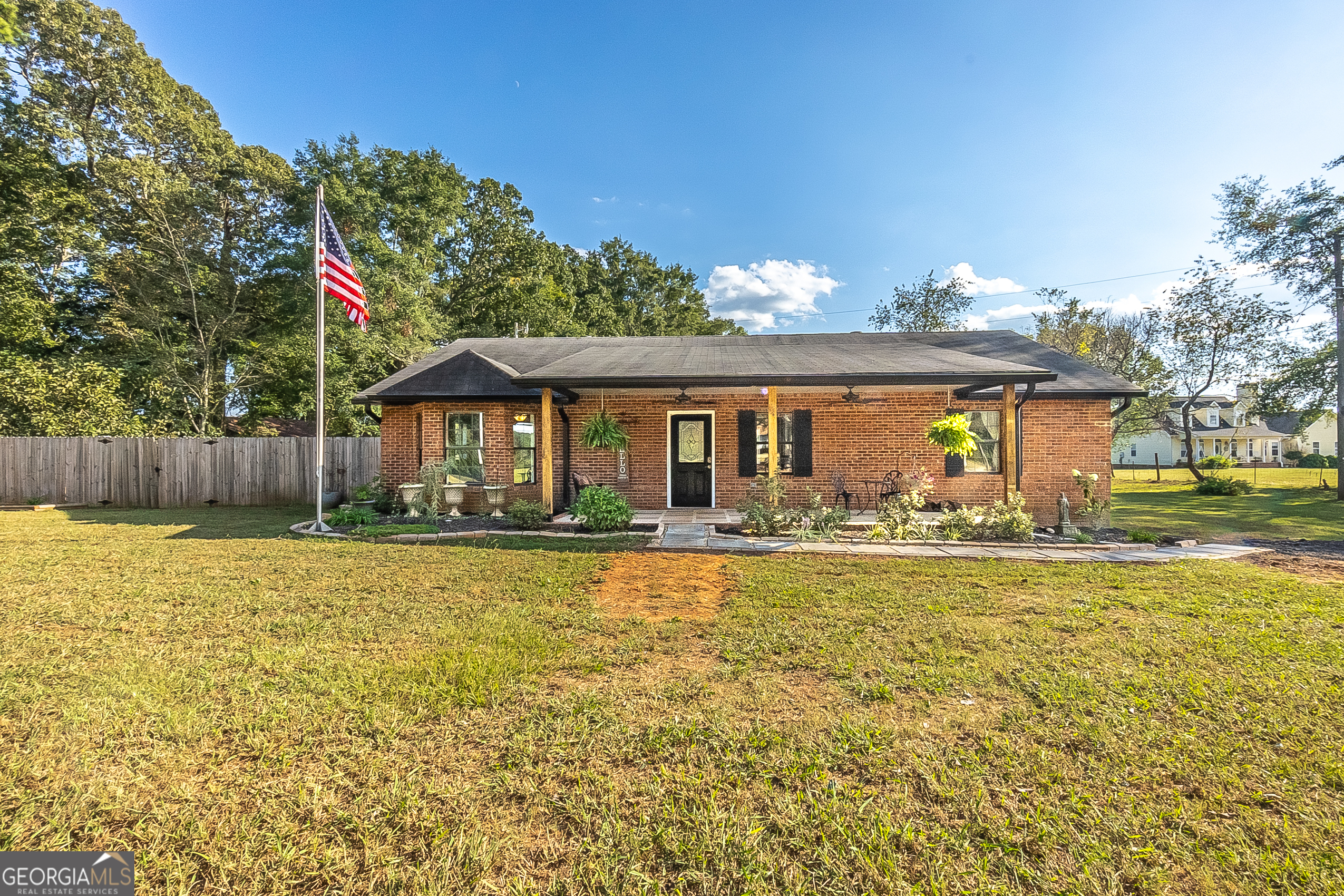 a front view of house with yard and outdoor seating