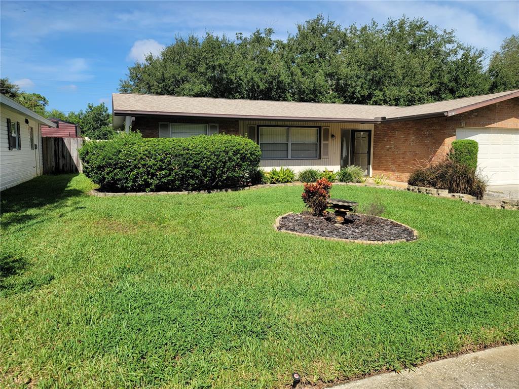 a view of a house with a yard and plants