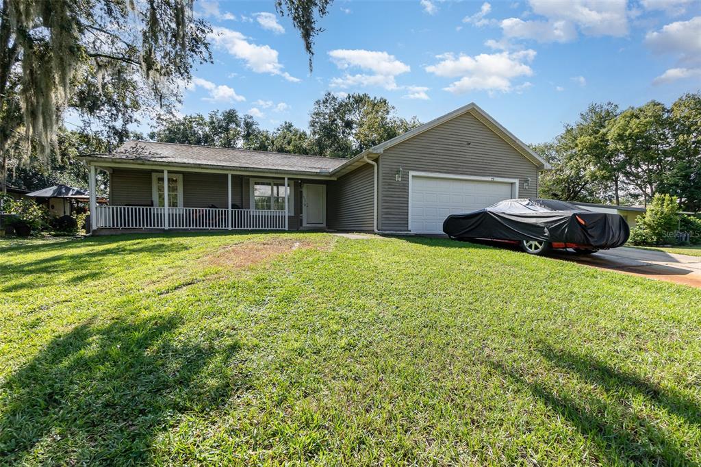 a front view of a house with yard and green space