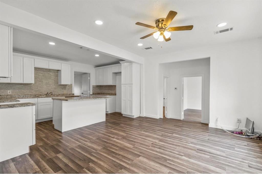 a view of kitchen with granite countertop cabinets and white appliances