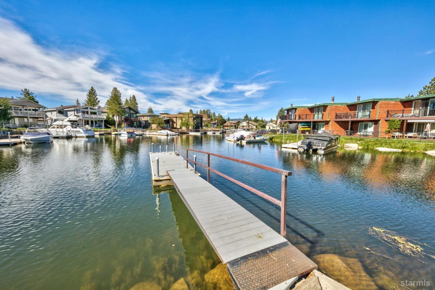 a view of a lake with boats and trees in the background