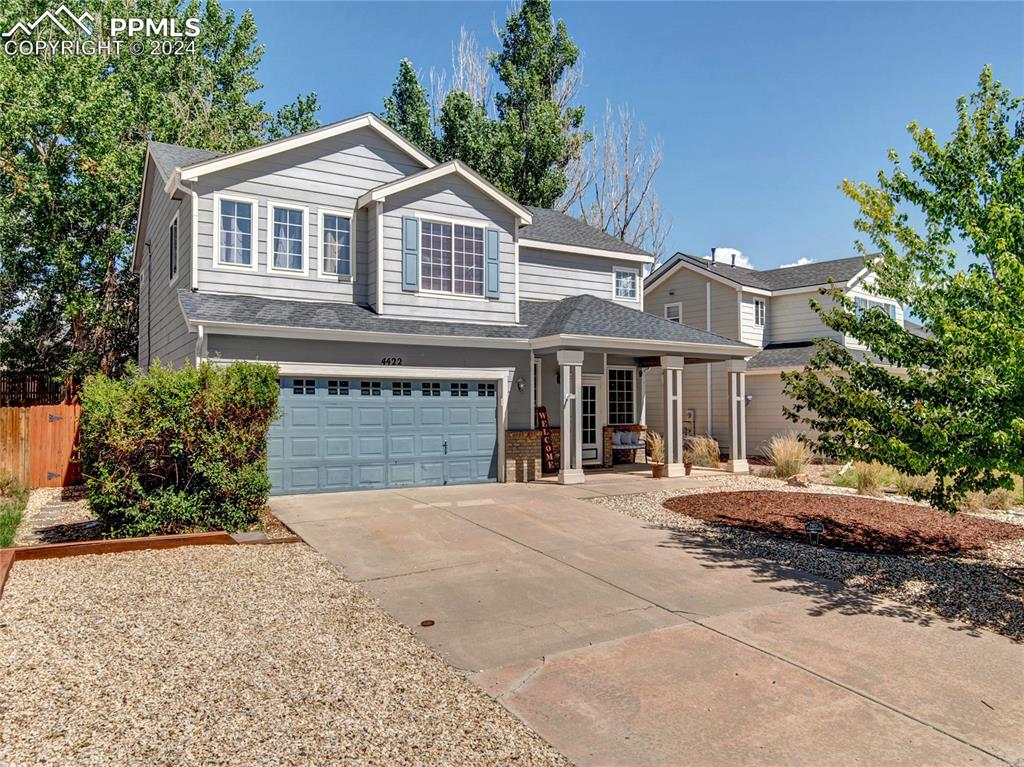 a front view of a house with yard and garage