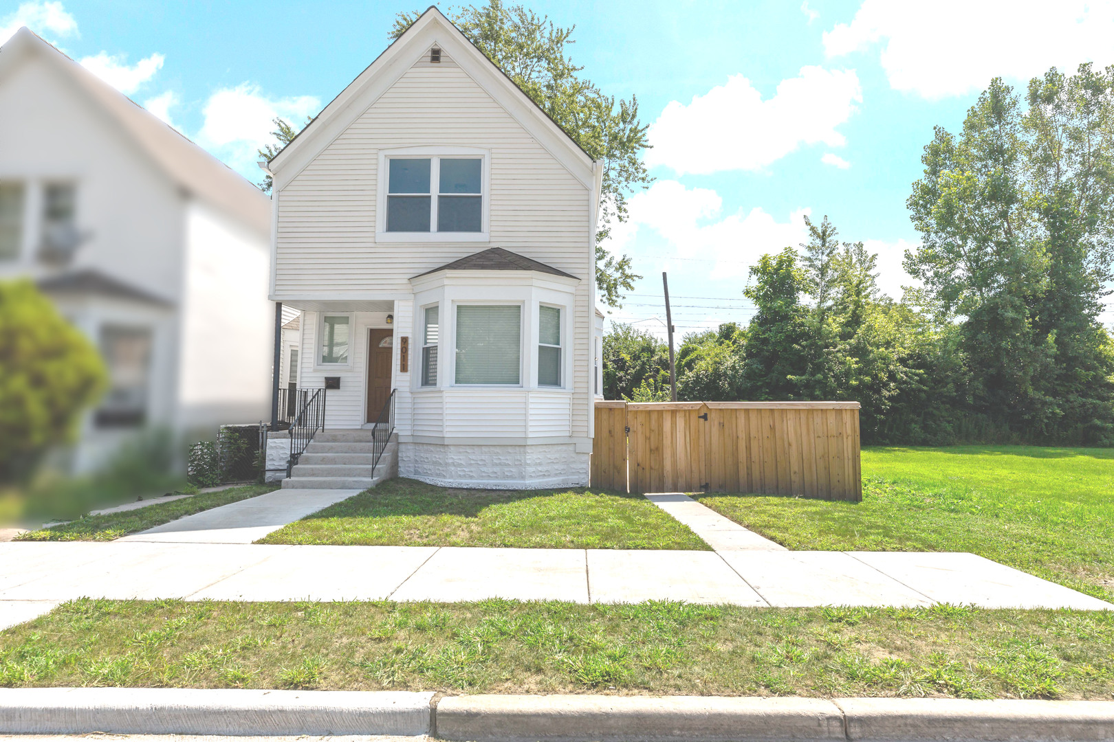 a view of a yard in front view of a house