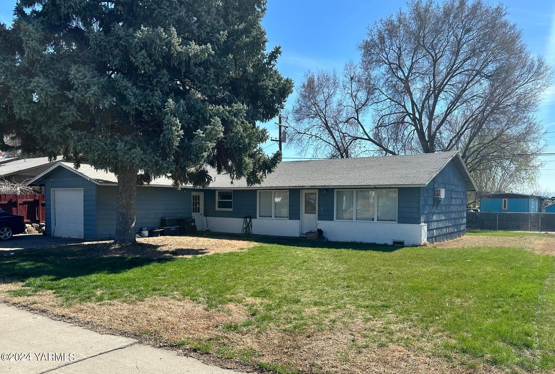 a view of a house with a yard and trees