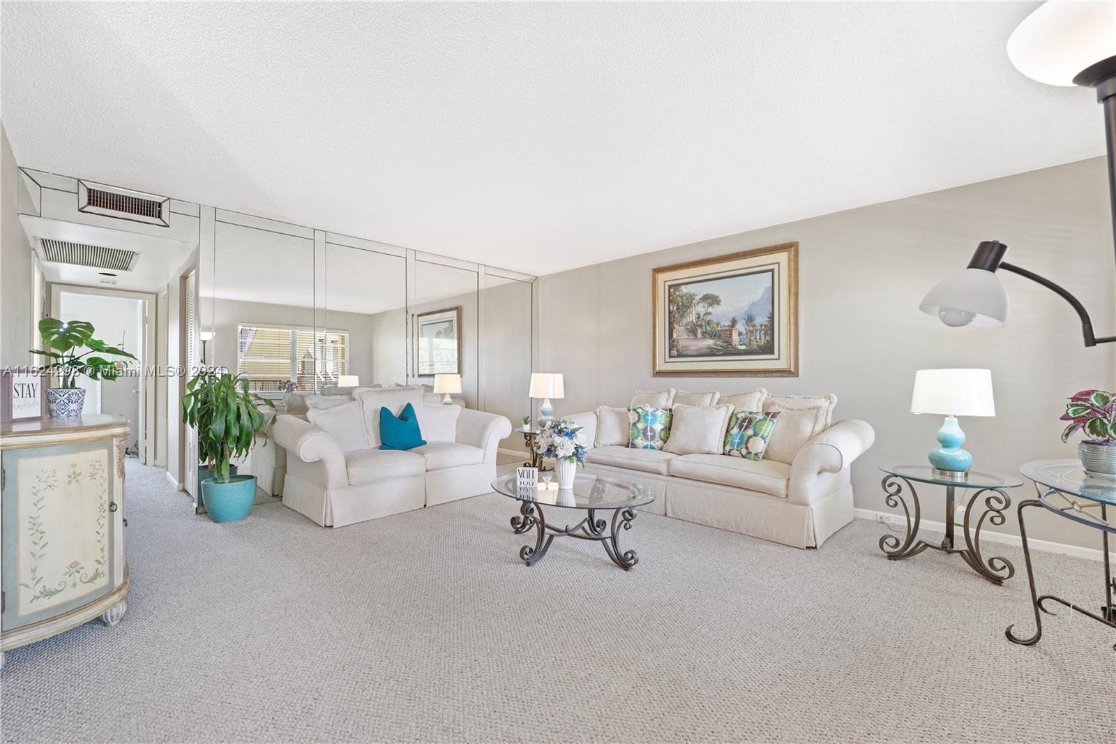 a living room with furniture and white walls