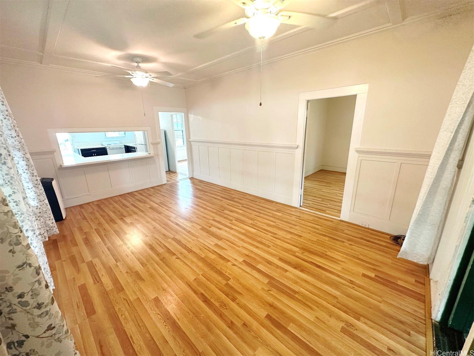 a view of a living room with wooden floor