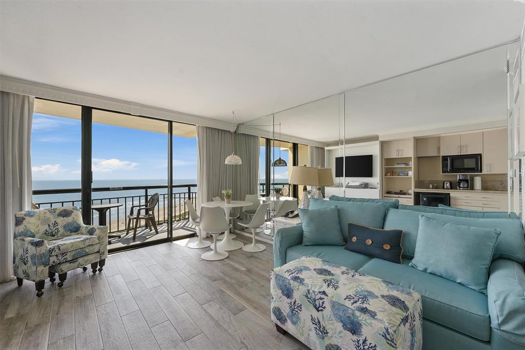 a living room with furniture and floor to ceiling window