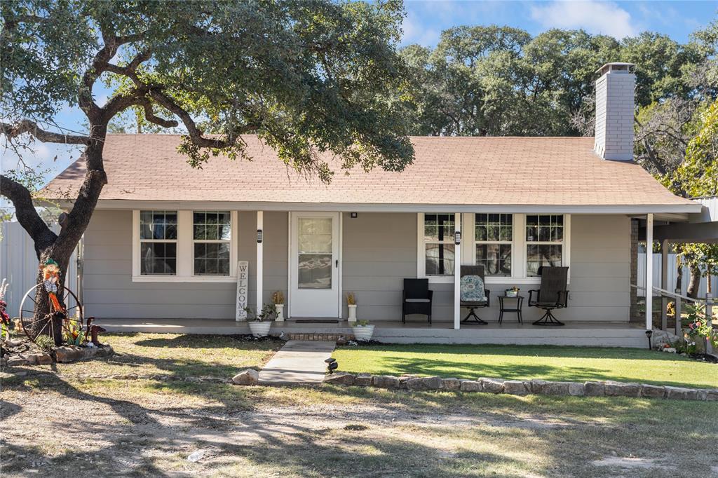 View of front lof the home, lawn and a covered porch