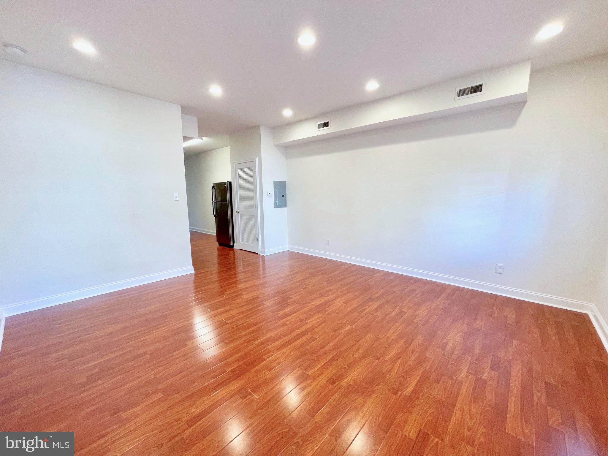 a view of a room with wooden floor